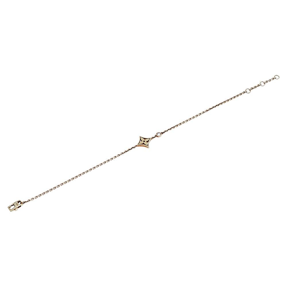 Show your love for fine artistry and luxury accessories with this stunning 18k yellow gold bracelet from Louis Vuitton. The Monogram flowers, created by Georges-Louis Vuitton, come alive in this creation through a single flower charm. The precious