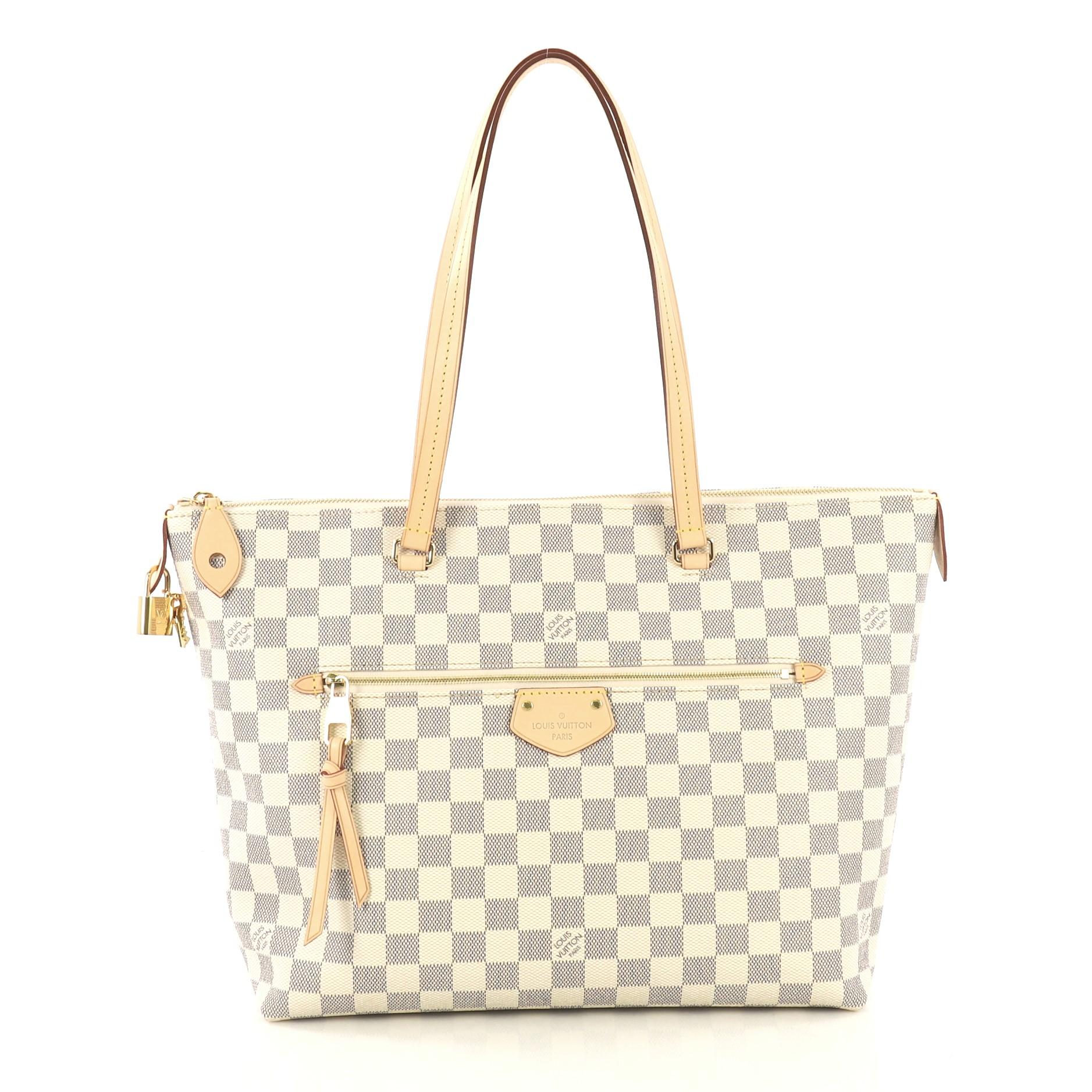 This Louis Vuitton Iena Tote Damier MM, crafted in damier azur coated canvas, features dual flat shoulder handles, natural cowhide leather trims, exterior zip pocket, and gold-tone hardware. Its zip closure opens to a pink fabric interior with slip
