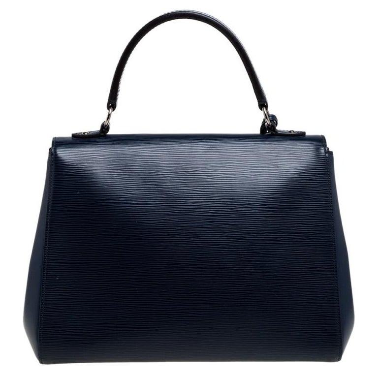All of Louis Vuitton's handbags are high on style and craftsmanship. Created from their signature Epi leather, the Cluny bag has a fine finish and a sleek silhouette. The bag features a top handle, a detachable shoulder strap, protective feet at the