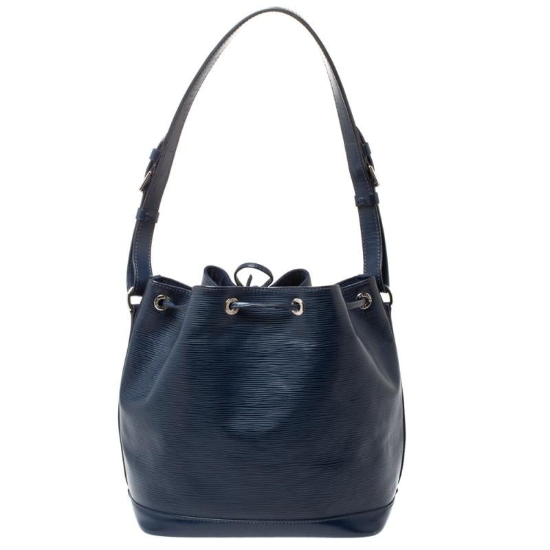 Created in 1932 by Louis Vuitton to carry bottles of Champagne, the iconic Noe now serves as a stylish daytime handbag. Crafted from blue epi leather, the bag exudes just the right amount of sophistication. It has a single adjustable strap with
