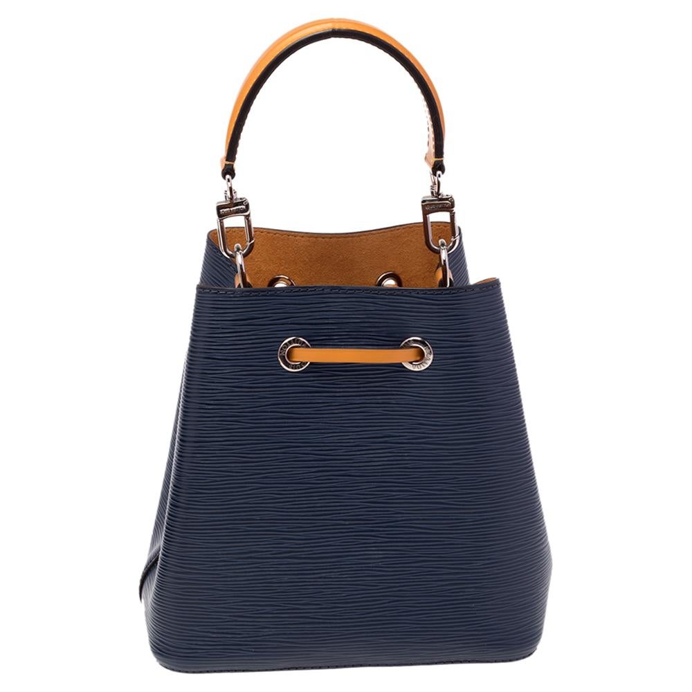 Louis Vuitton's NéoNoé bag was made to carry Champagne bottles in style; this contemporary iteration is crafted from Epi leather and features a sleek yet malleable shape, contrasting leather trim, and an Alcantara interior. The adjustable slender