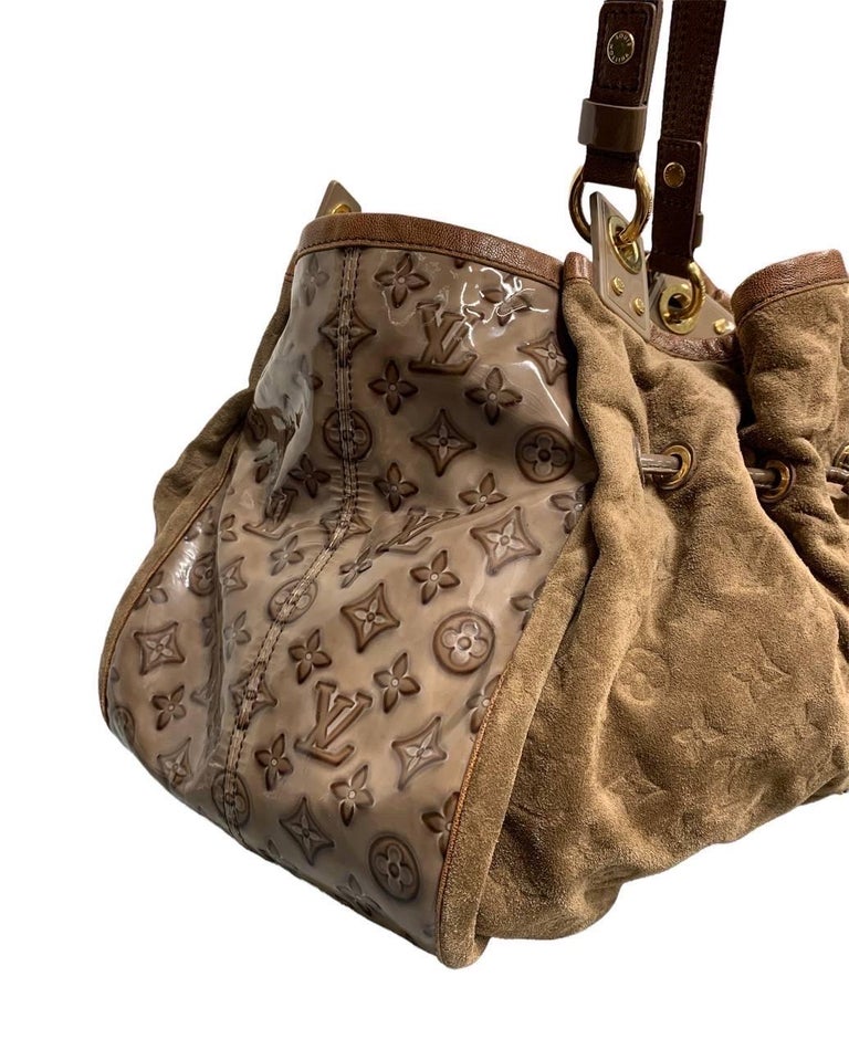 This authentic Louis Vuitton Irene Handbag Monogram Embossed Suede and Patent presented in the brand's Spring/Summer 2009 Collection showcases a classic design with a modern, eye-catching twist. This elegant tote features two flat handles, brown