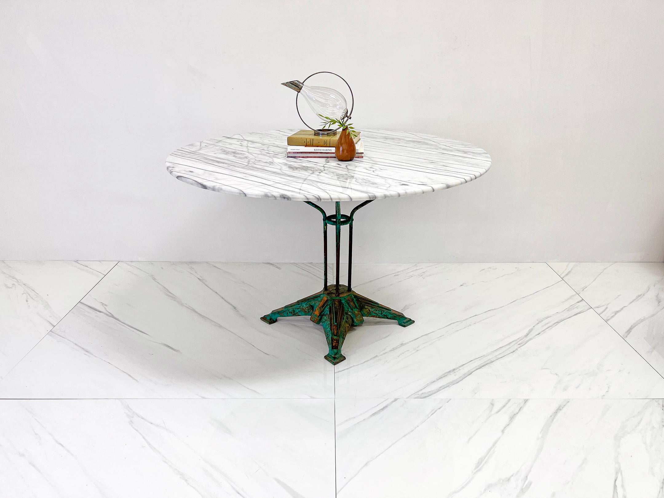 This table is absolutely stunning. A vintage iron Louis Vuitton dining or display table with a custom marble top. We acquired this table with a bit of lore to be had-- when we purchased it, we found it at an antique fair from a dealer who had
