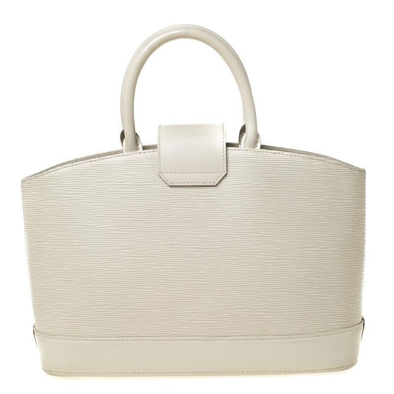 Everybody wants a bag as fabulous as this one from Louis Vuitton. It is made from high-quality Epi leather and designed to assist you every day. The bag carries a cream hue and a turn lock that leads to an Alcantara-lined interior which will