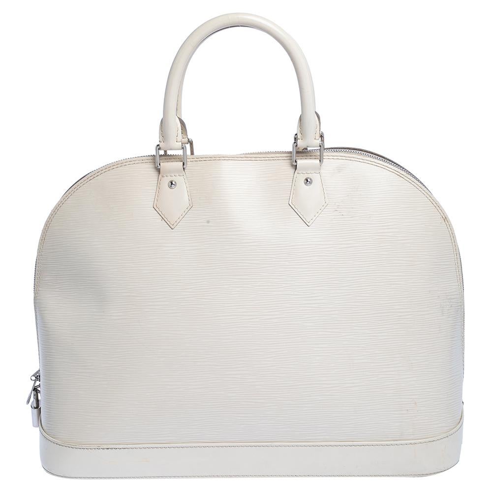 The Louis Vuitton Alma is a classic that has received love from icons. This piece comes crafted from Epi leather, featuring double zippers with an Alcantara interior. Two rolled handles are provided for you to elegantly parade it. Every closet