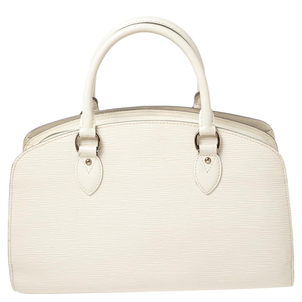 Louis Vuitton's handbags are popular owing to their high style and functionality. This Pont Neuf bag, like all the other handbags, is durable and stylish. Crafted from Epi leather, the bag comes with two top handles, top zip closure, and a