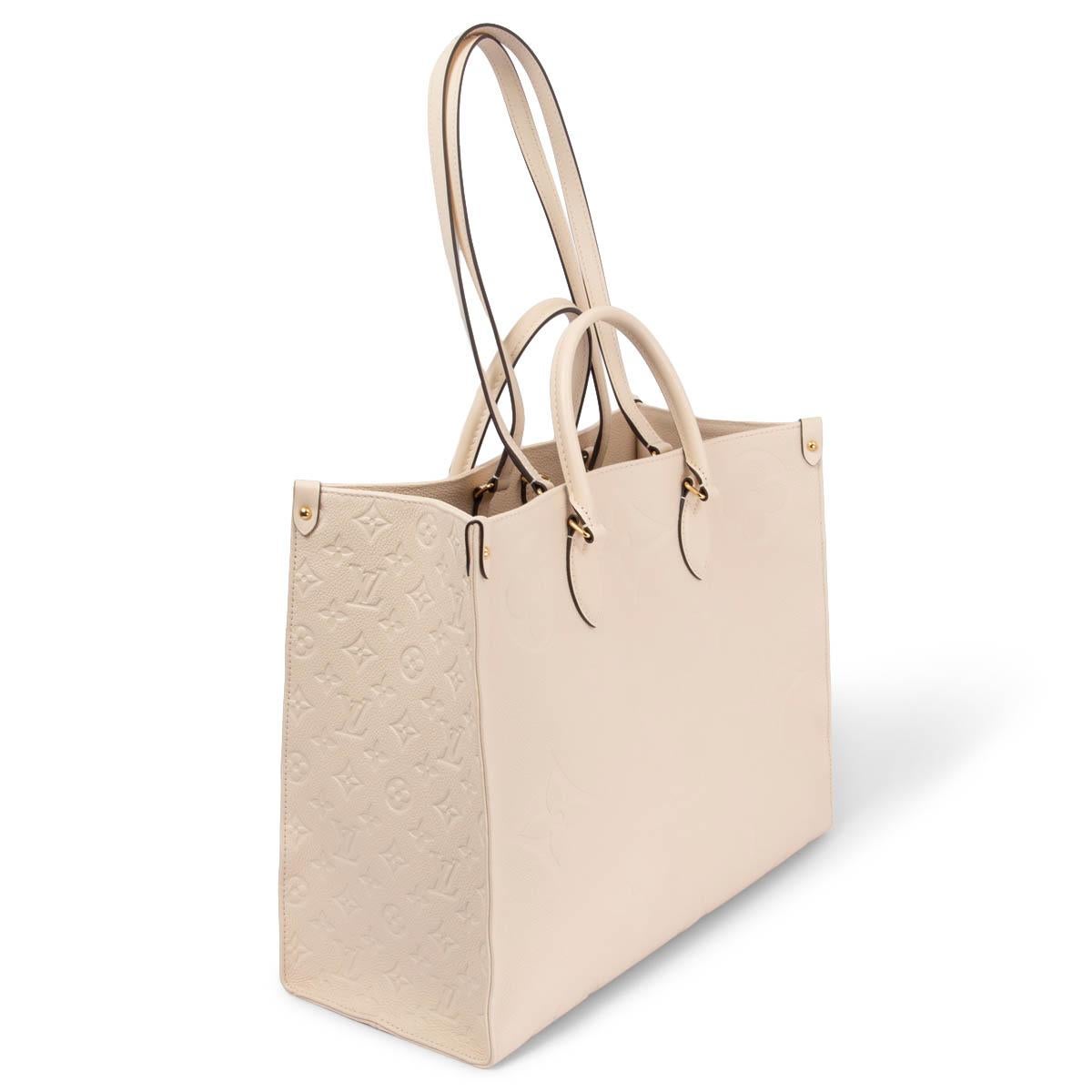 100% authentic Louis Vuitton OnTheGo GM Tote Giant Monogram Empreinte ivory leather featuring gold-tone hardware. Lined in beige alcantara with one zipper pocket and two patch pockets against the back. Coses with a snap hook. Has been carried one ot
