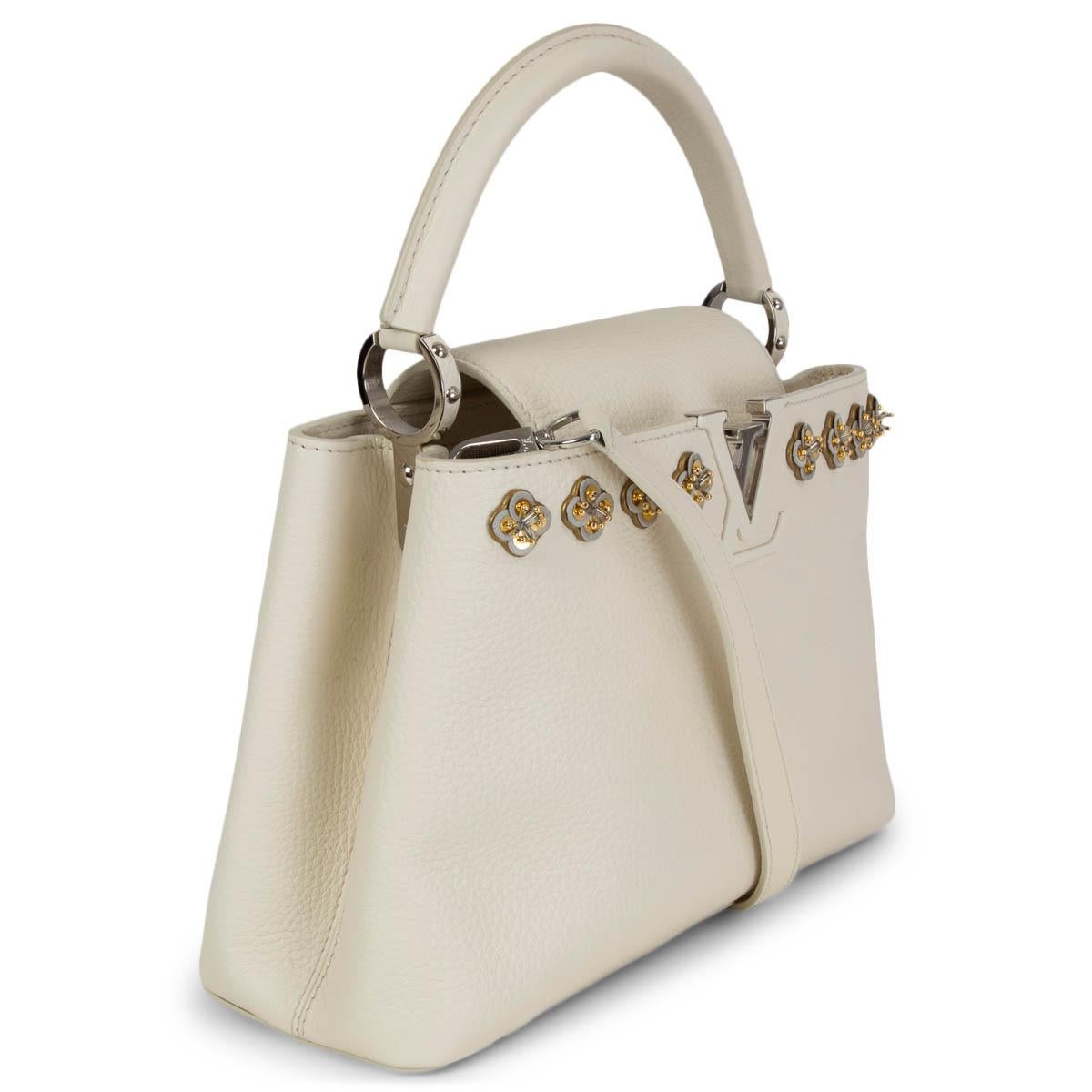 100% authentic Louis Vuitton Capucines 2018 Limited Edition PM Hanami Applique handbag in blanc (off-white) grained calfskin featuring silver-tone hardware. Opens with a flap on top and the interior is devided in two departments. Lined in white