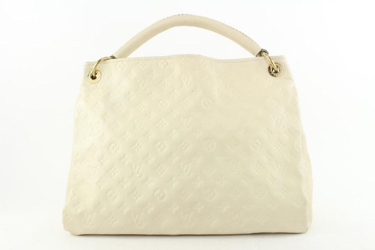 Louis Vuitton Ivory Neige Monogram Empreinte Leather Artsy MM Hobo Bag In Good Condition For Sale In Dix hills, NY