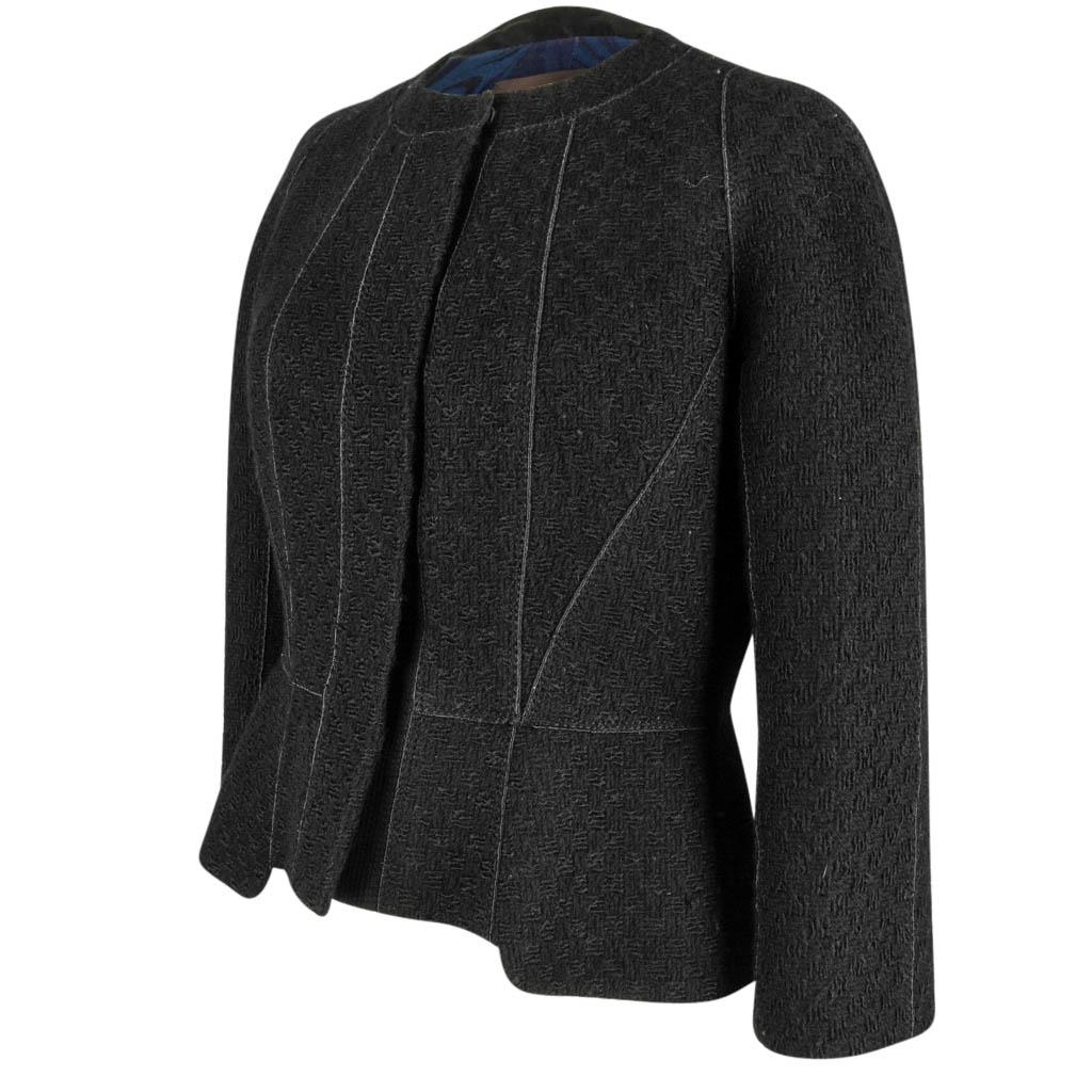 Mightychic offers a Louis Vuitton exquisite 3/4 sleeve jacket with matching bead detailed scarf.
Beautifully shaped and features black richly textured fabric.  
Detailed stitch detail accentuates the gorgeous lines of the jacket.
No collar.
Hidden