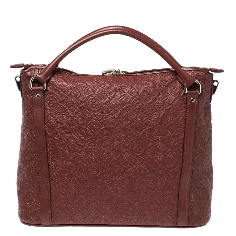 Louis Vuitton's handbags are popular owing to their high style and functionality. This Antheia Ixia PM bag, like all the other handbags, is durable and stylish. Crafted from monogram leather, the red bag can be paraded using the top handles or the