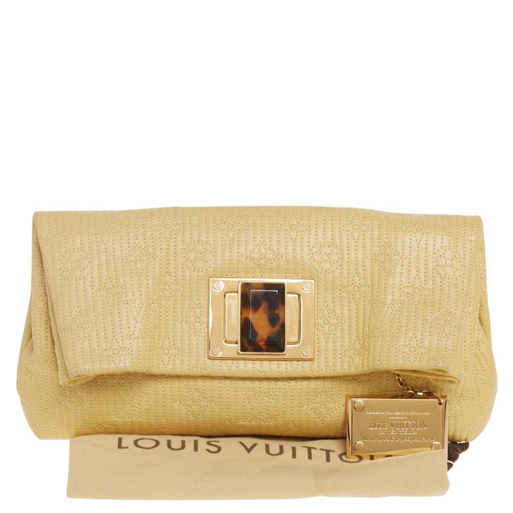 This Louis Vuitton Limited Edition Altair clutch weaves luxury with utility. Crafted using monogram leather, this Jaune Pale clutch will keep your essentials safe. It features a twist-lock lock to secure the fabric interior.

