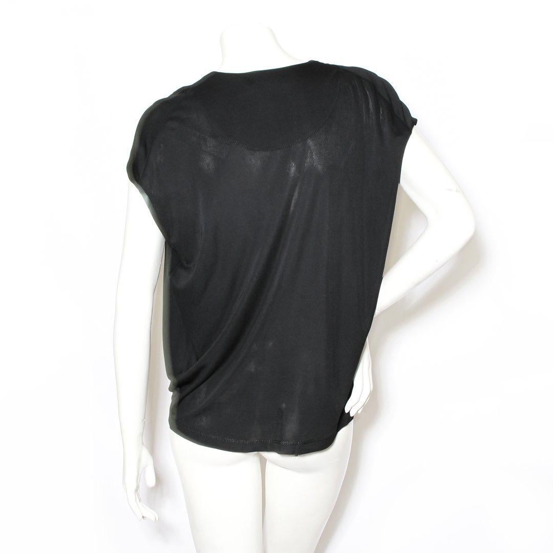 Jersey blouse by Louis Vuitton
Circa early 2000s
Black
Tie sleeve/ ruched sleeve
Cowl neck 
LV monogram interior 
Slip-on
Short sleeve
Made in France
Condition: Excellent, little to no visible wear. (see photos) 

Size/Measurements: (approximate,