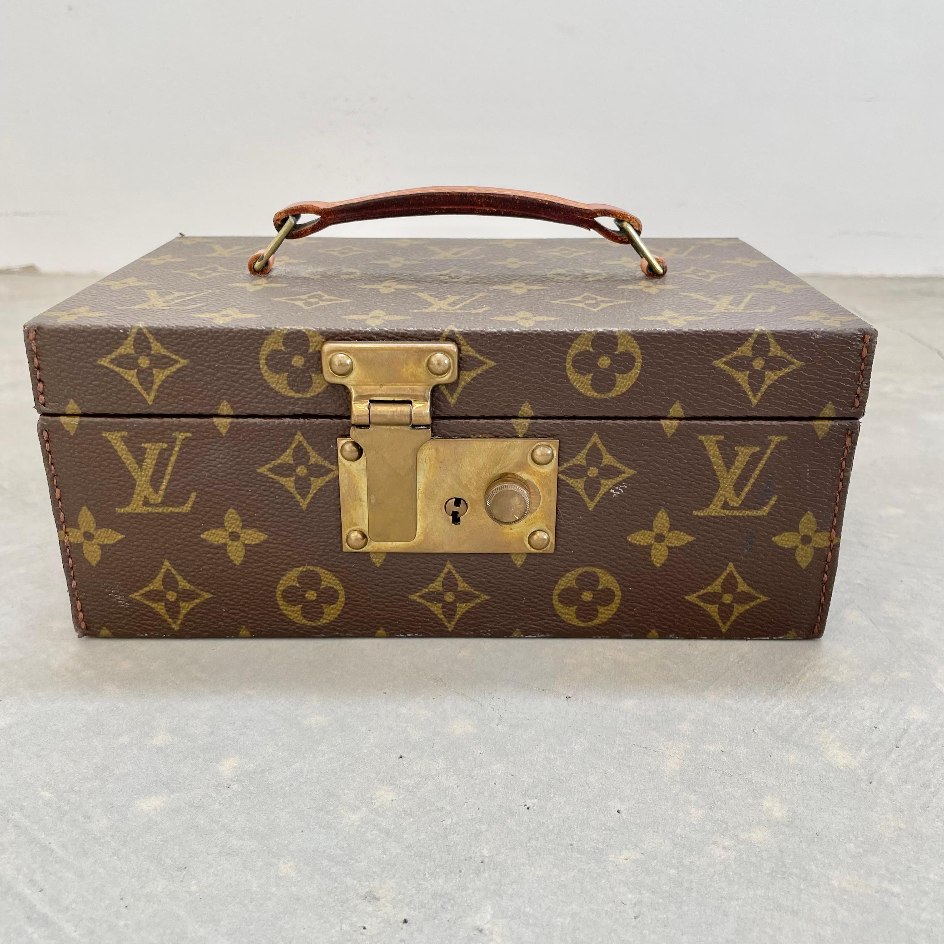 Beautiful Louis Vuitton jewelry box from the 1940s. Perfect for all of your high end jewelry while traveling or as a stationary box at home. Tan interior lining with velvet at the bottom. Includes velvet lined ring holder and jewelry cushion. The