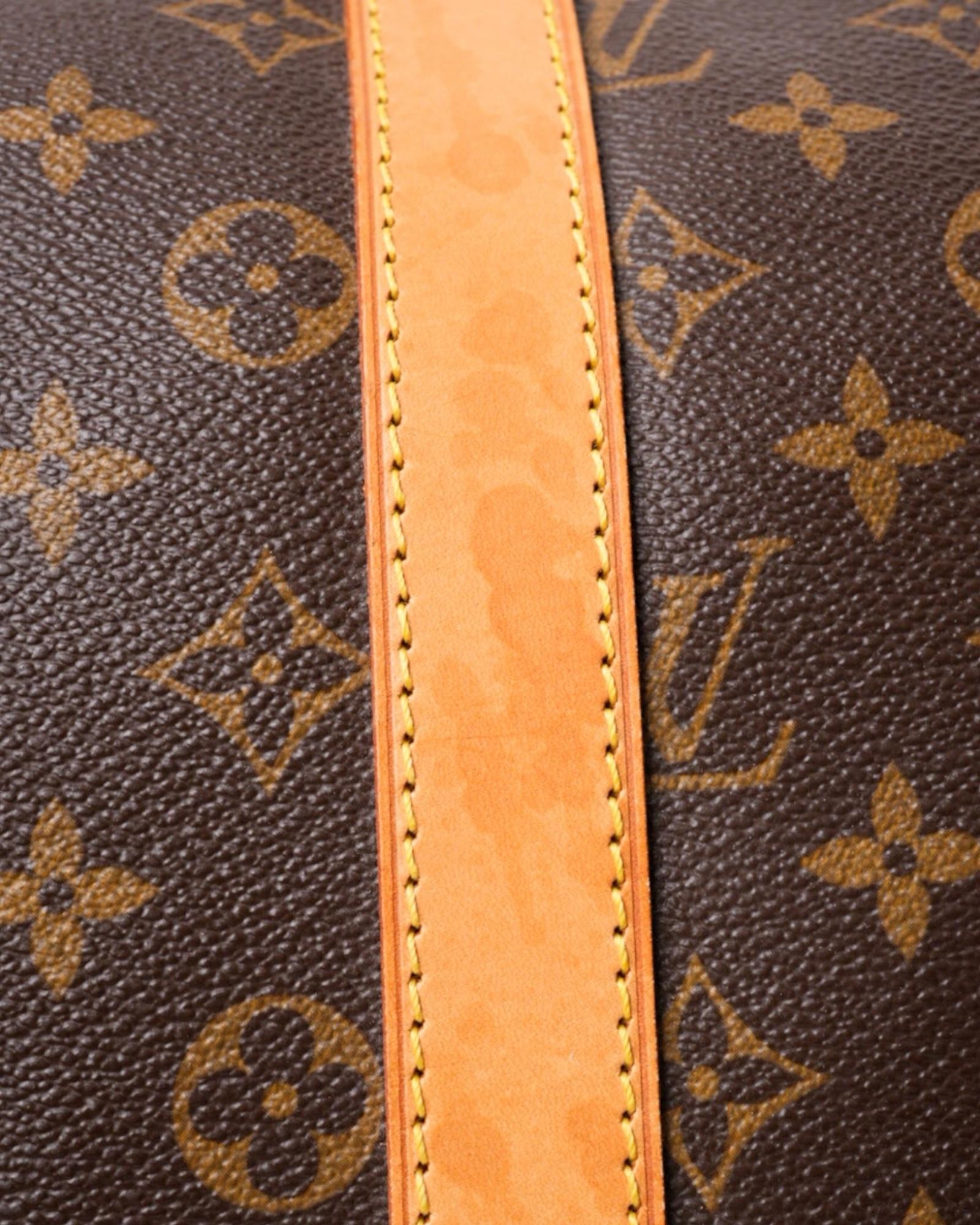 Louis Vuitton signature travel duffel bag, model Keepall 45 made of brown canvas in monogram pattern, with cowhide inserts and gold hardware. This model features a double-slider zipper top closure, allowing easy access to its spacious interior,