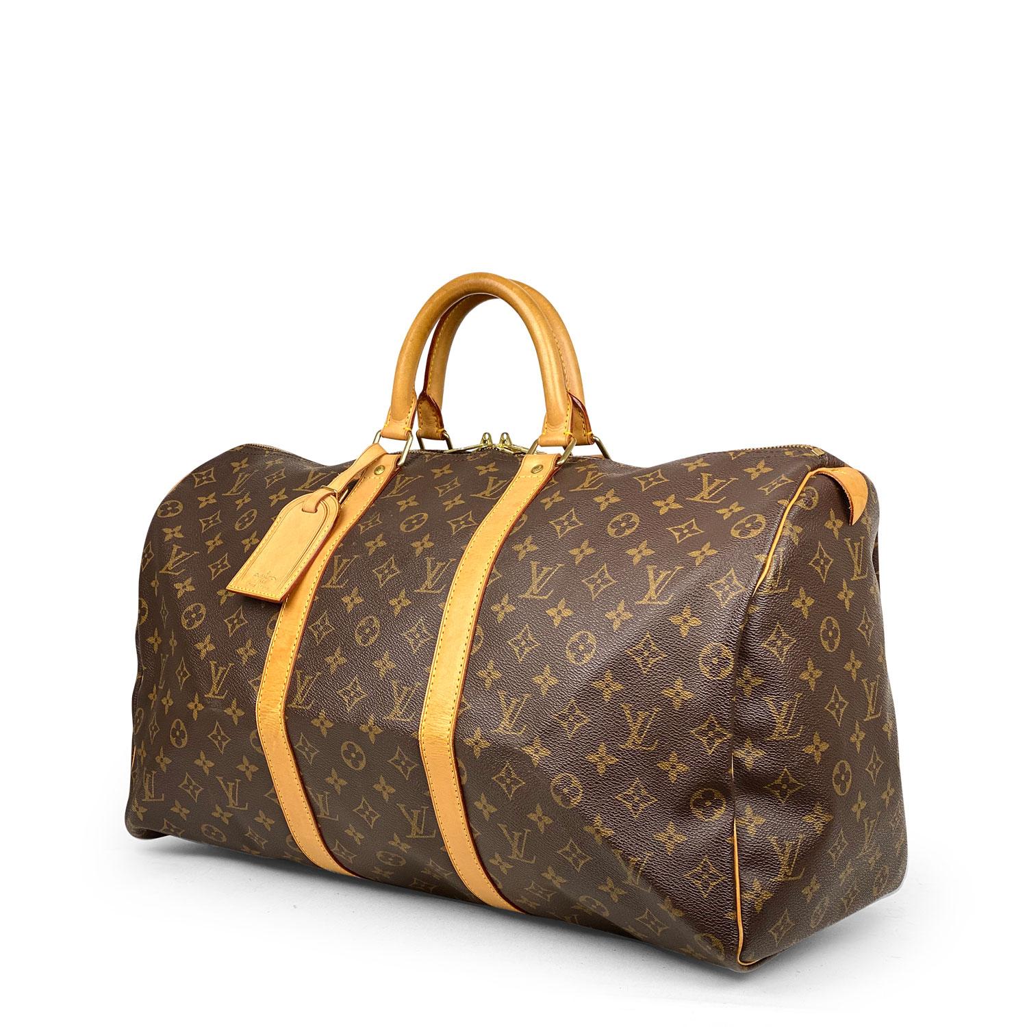 Brown and tan monogram coated canvas Louis Vuitton Keepall 50 with

- Brass hardware
- Tan vachetta leather trim
- Dual rolled top handles
- Tonal canvas lining and two-way zip closure at top

Overall Preloved Condition: Very Good
Exterior