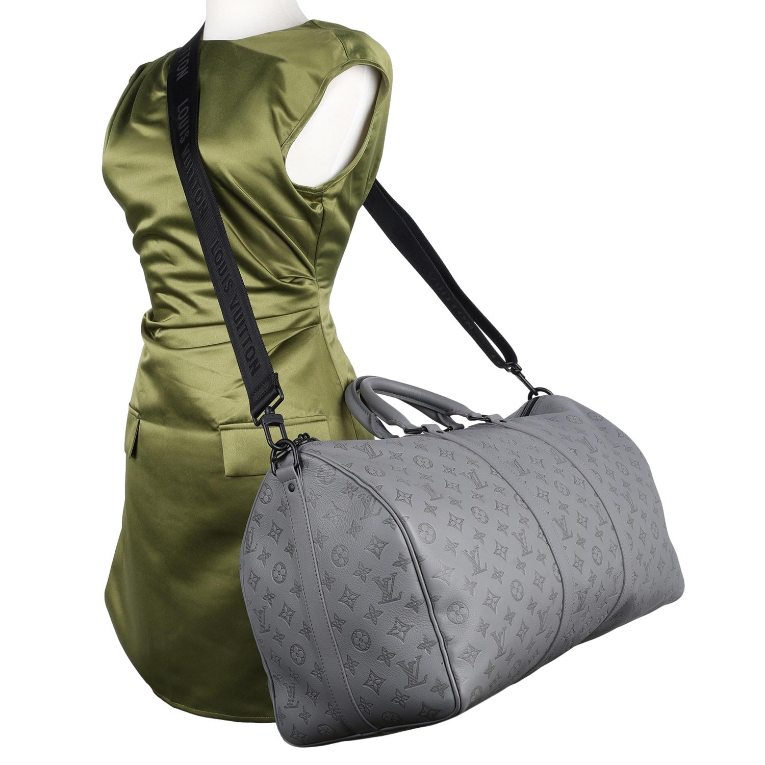 Authentic Louis Vuitton Keepall  50B Bandouliere duffle bag. 

Features

Cabin-size
Monogram Shadow Soft Leather in grey. 
Cowhide leather trim
Textile lining
Black hardware
Zip closure system
Inside zipped pocket
Large capacity
Strap: Removable,