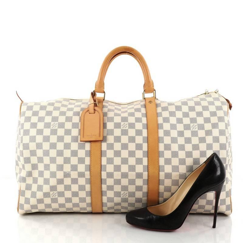 This authentic Louis Vuitton Keepall Bag Damier 50 is the perfect bag for a weekend trip, and can be effortlessly paired with any outfit from casual to formal. Crafted with damier azur coated canvas, this classic travel-sized duffle features
