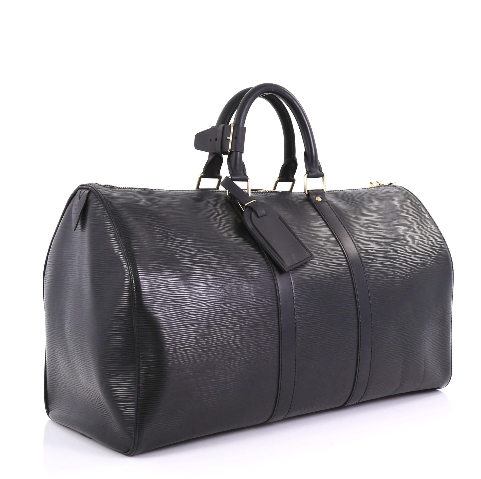 This Louis Vuitton Keepall Bag Epi Leather 45, crafted from black epi leather, features dual rolled handles, subtle LV logo, and gold-tone hardware. Its zip closure opens to a black raw leather interior. Authenticity code reads: SP0034. 

Estimated