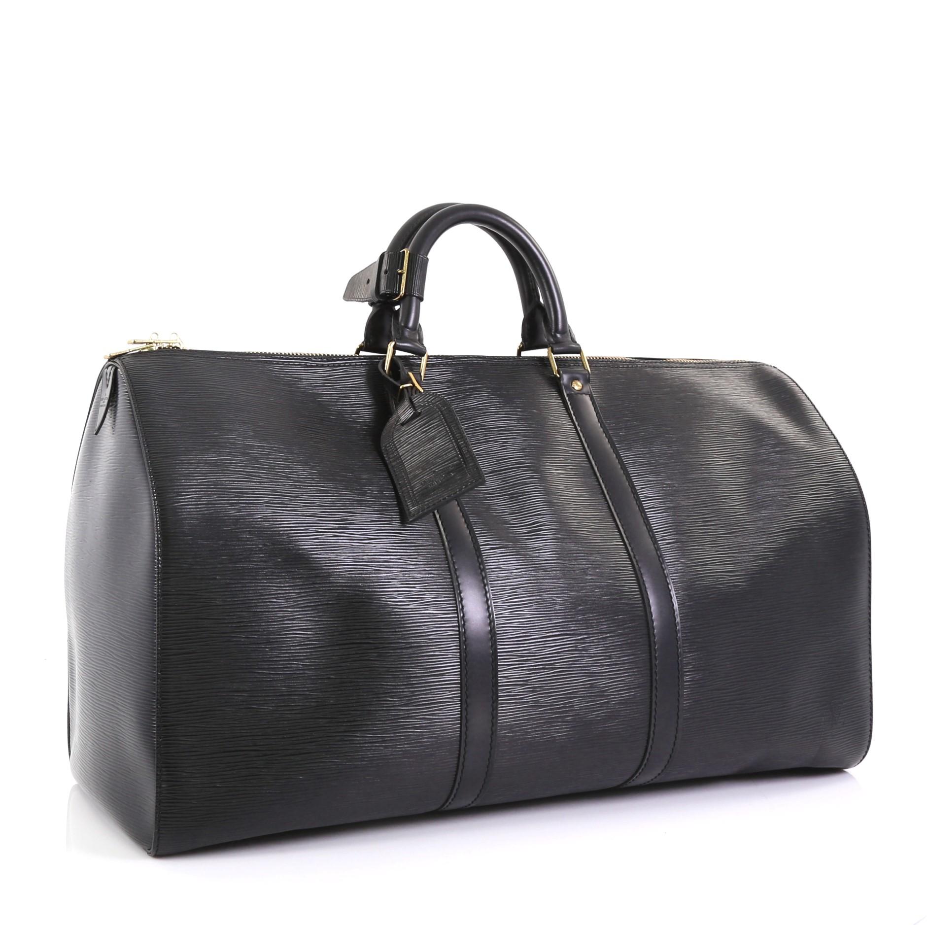 This Louis Vuitton Keepall Bag Epi Leather 50, crafted from black epi leather, features dual rolled handles, subtle LV logo, and gold-tone hardware. Its zip closure opens to a black raw leather interior. Authenticity code reads: VI8911. 

Estimated