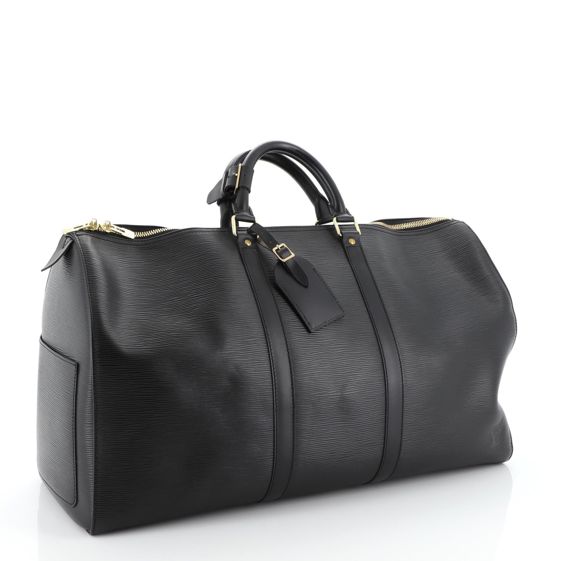 This Louis Vuitton Keepall Bag Epi Leather 55, crafted from black epi leather, features dual rolled handles, subtle LV logo and gold-tone hardware. Its zip closure opens to a black raw leather interior. Authenticity code reads: SP0012. 

Estimated