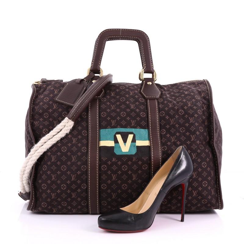 This Louis Vuitton Keepall Bag Limited Edition Initiales Mini Lin, crafted in brown mini lin, features dual dark brown leather top handles, bold green and yellow monogram 