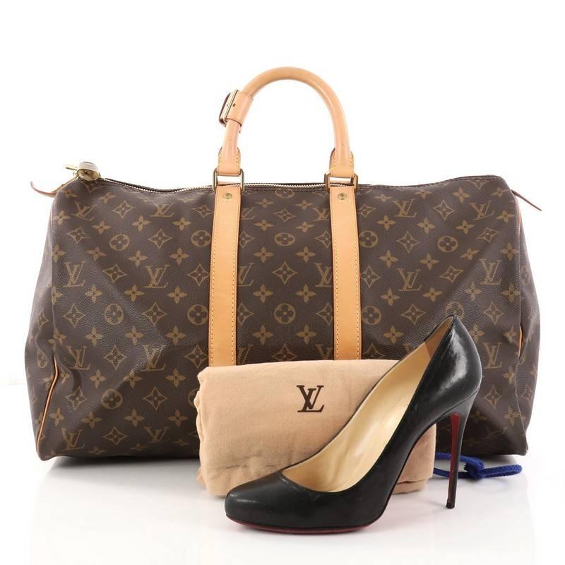 This authentic Louis Vuitton Keepall Bag Monogram Canvas 45 is the perfect purchase for a weekend trip, and can be effortlessly paired with any outfit from casual to formal. Crafted from traditional Louis Vuitton brown monogram coated canvas, this