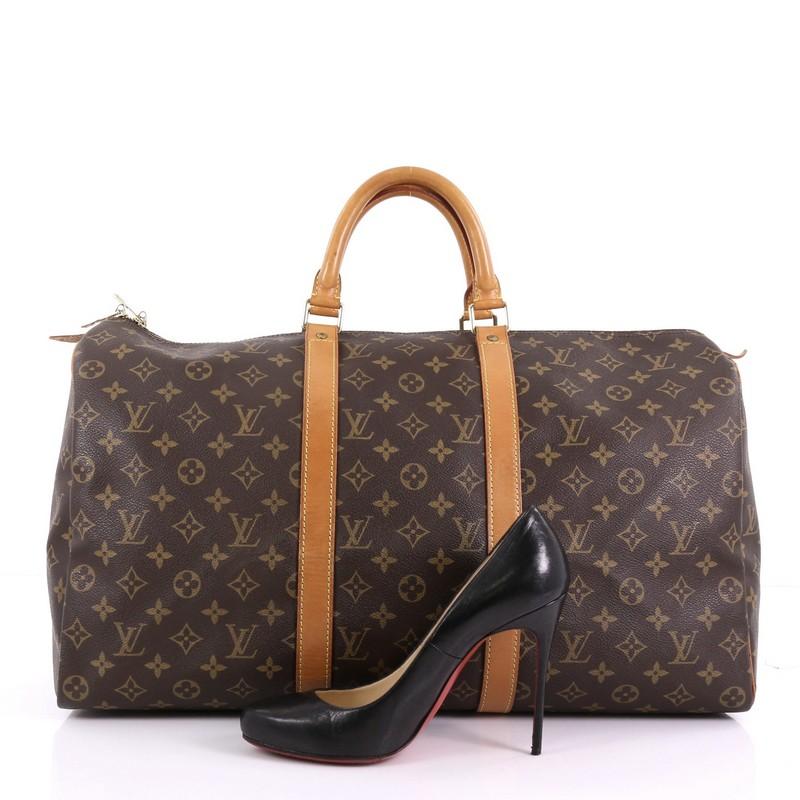 This Louis Vuitton Keepall Bag Monogram Canvas 50, crafted in brown monogram coated canvas, features dual rolled leather handles, vachetta leather trim, and gold-tone hardware. Its two-way zip closure opens to a brown fabric interior. Authenticity