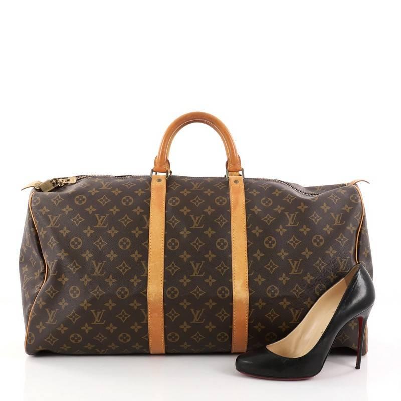 This authentic Louis Vuitton Keepall Bag Monogram Canvas 55 is the perfect purchase for a weekend trip, and can be effortlessly paired with any outfit from casual to formal. Crafted from traditional brown monogram coated canvas, this luxurious