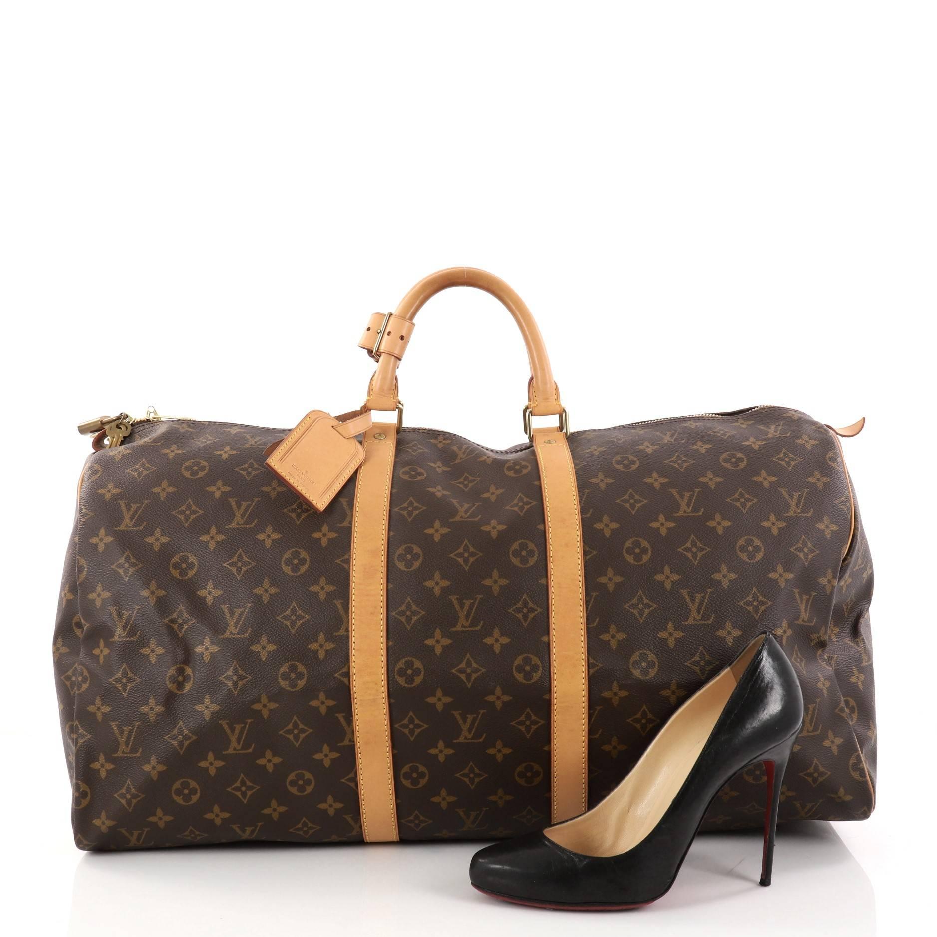 This authentic Louis Vuitton Keepall Bag Monogram Canvas 55 is the perfect purchase for a weekend trip, and can be effortlessly paired with any outfit from casual to formal. Crafted from traditional Louis Vuitton brown monogram coated canvas, this