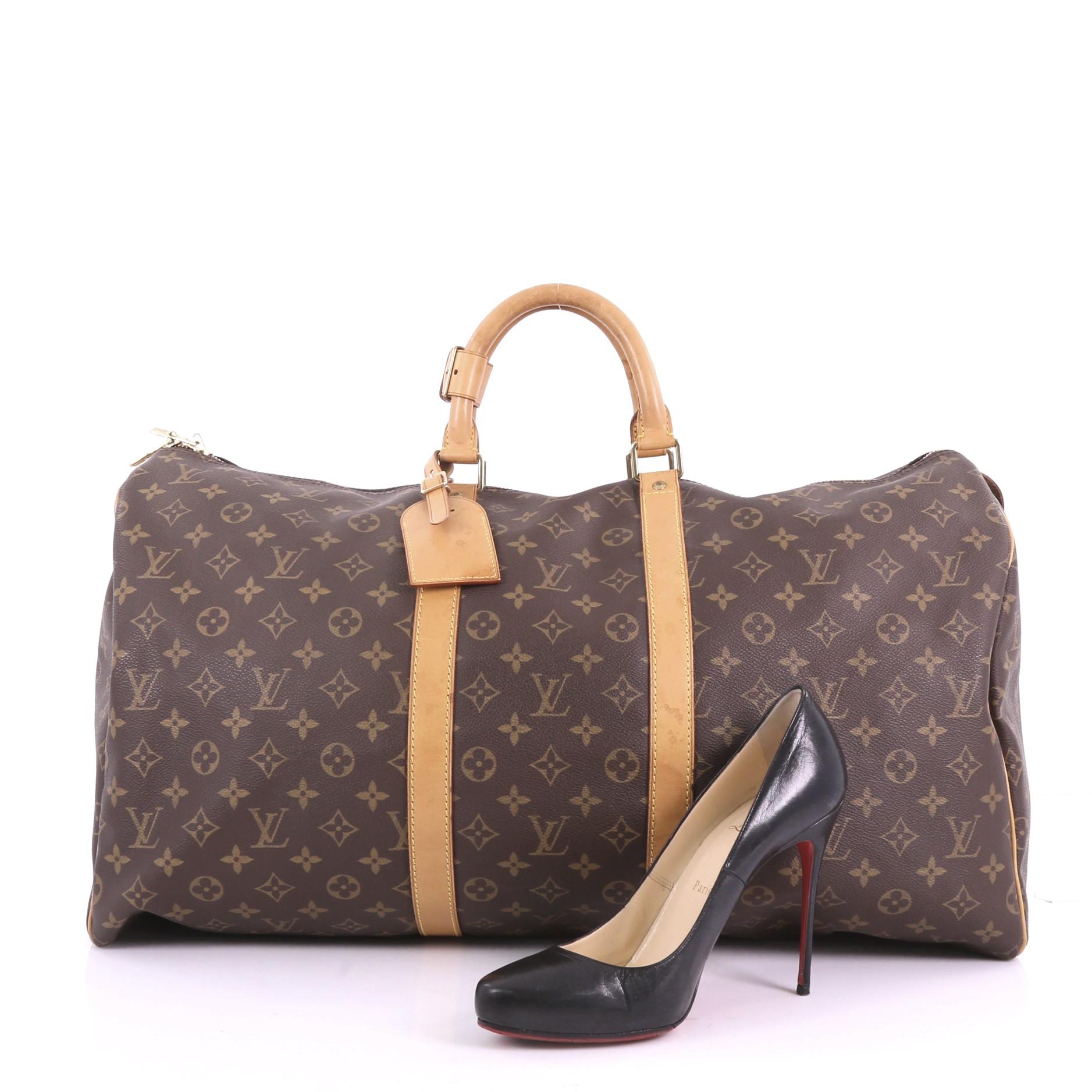 This Louis Vuitton Keepall Bag Monogram Canvas 55, crafted in brown monogram coated canvas, features dual rolled leather handles, vachetta leather trim, and gold-tone hardware. Its two-way zip closure opens to a brown fabric interior. Authenticity