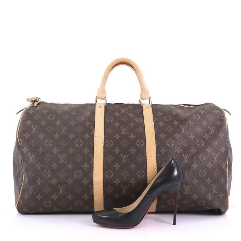 This Louis Vuitton Keepall Bag Monogram Canvas 55, crafted in brown monogram coated canvas, features dual rolled leather handles, vachetta leather trims and gold-tone hardware. Its two-way zip closure opens to a brown fabric interior. Authenticity