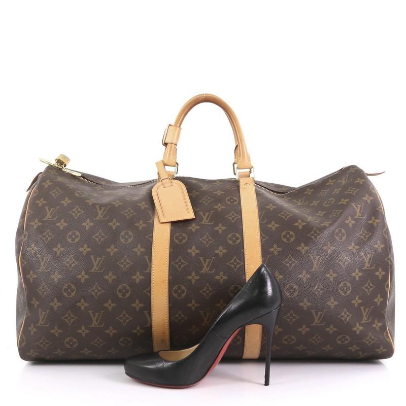 This Louis Vuitton Keepall Bag Monogram Canvas 55, crafted in brown monogram coated canvas, features dual rolled leather handles, vachetta leather trim, and gold-tone hardware. Its two-way zip closure opens to a brown fabric interior. Authenticity