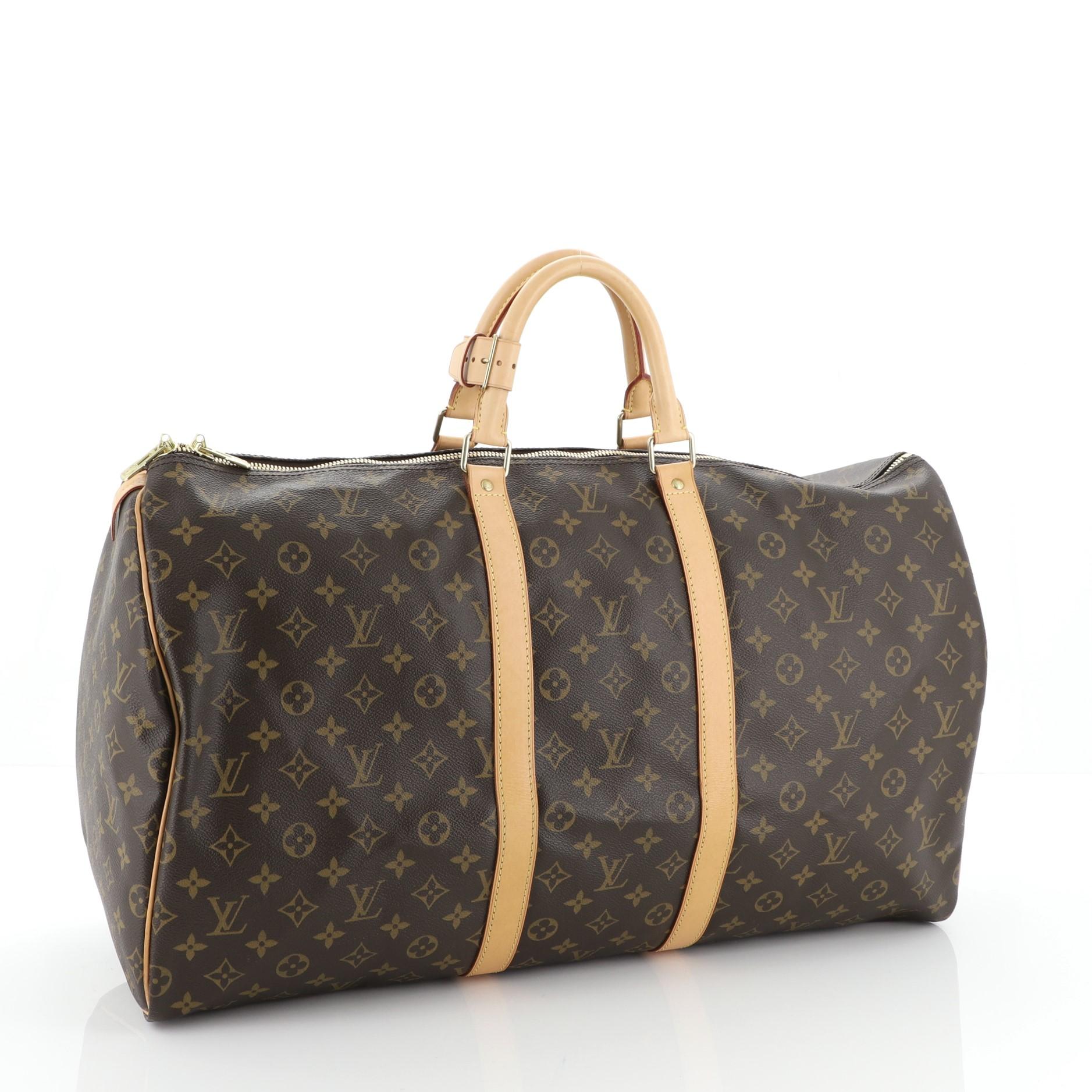 This Louis Vuitton Keepall Bag Monogram Canvas 55, crafted in brown monogram coated canvas, features dual rolled leather handles, vachetta leather trim, and gold-tone hardware. Its two-way zip closure opens to a brown fabric interior. Authenticity