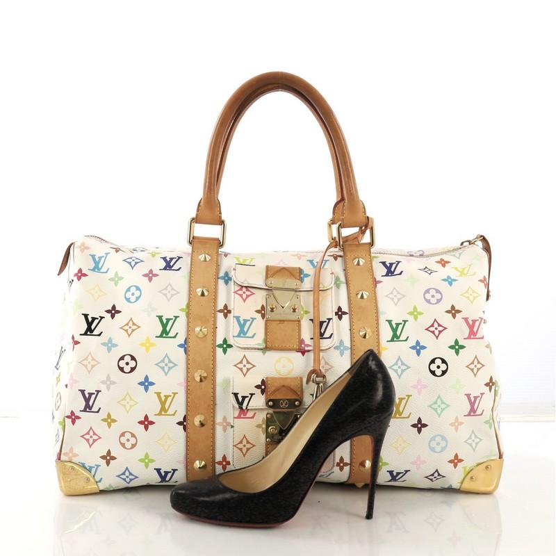 This Louis Vuitton Keepall Bag Monogram Multicolor 45, crafted with white multicolor monogram coated canvas, features dual rolled leather handles, studded leather trim, two exterior front pockets with push-lock closure, and gold-tone hardware. Its