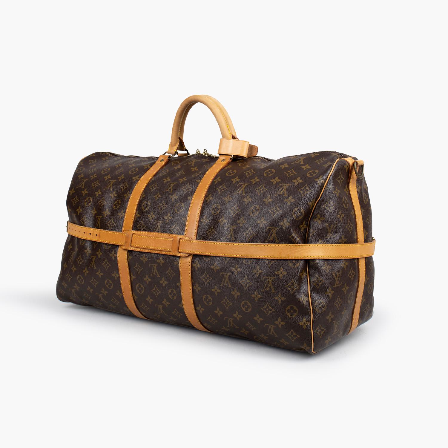 Brown and tan monogram coated canvas Louis Vuitton Keepall Bandoulière 60 with

- Brass hardware
- Tan vachetta leather trim
- Dual rolled top handles
- Tonal canvas lining and two-way zip closure at top

Overall Preloved Condition: Good
Exterior