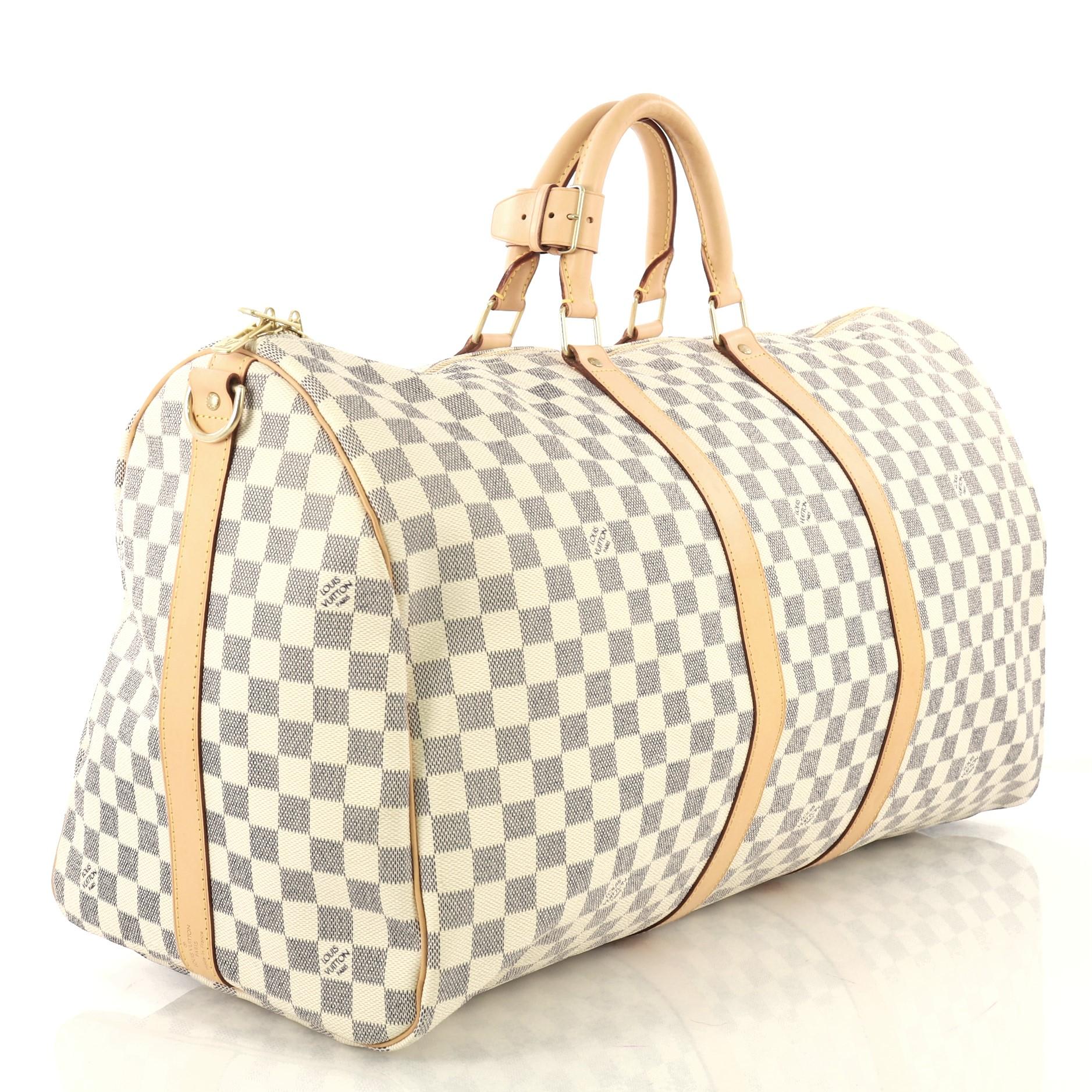 This Louis Vuitton Keepall Bandouliere Bag Damier 55, crafted from damier azur coated canvas, features dual rolled handles, leather trim, and gold-tone hardware. Its two-way top zip closure opens to a beige fabric interior. Authenticity code reads: