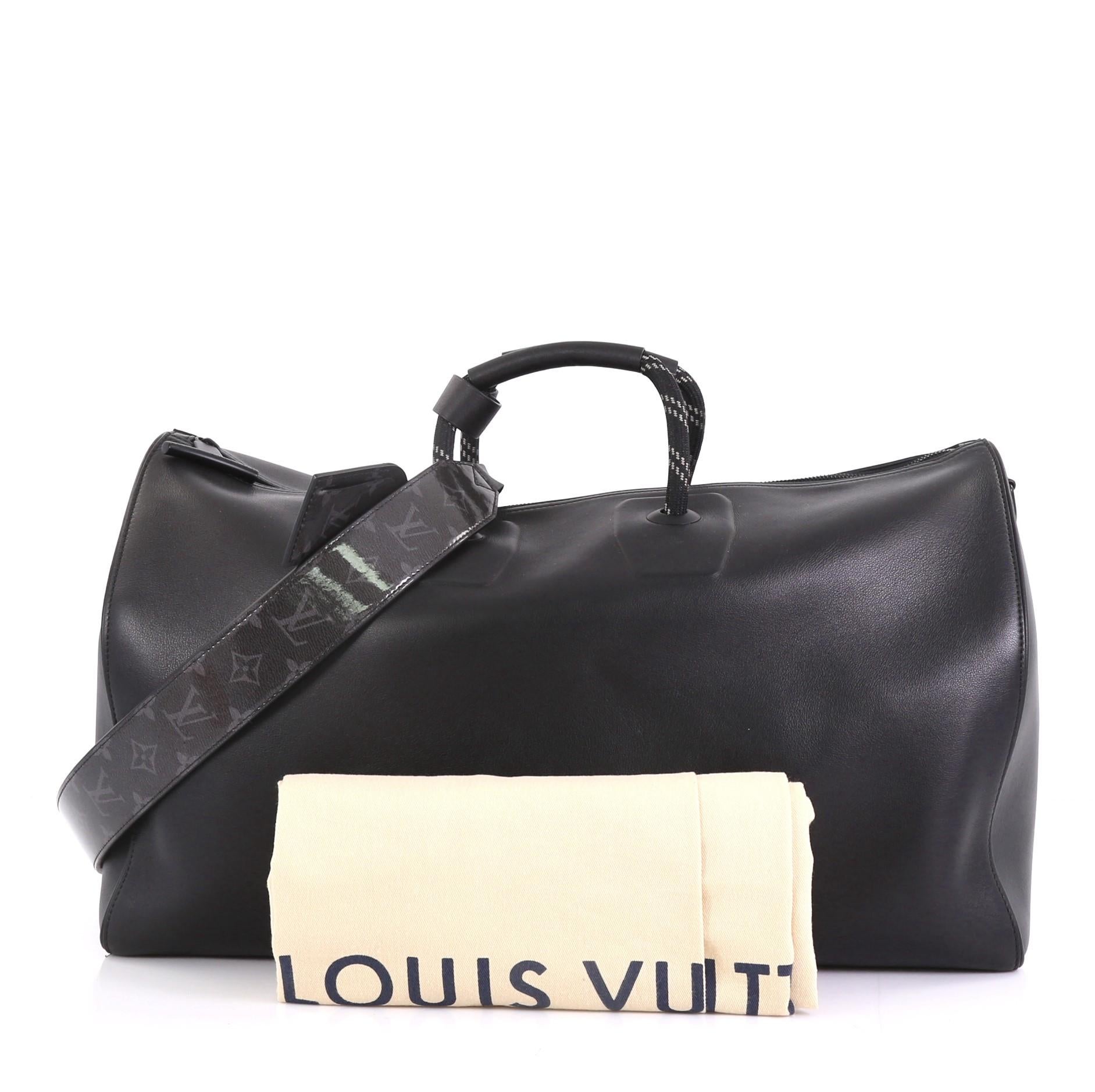 This Louis Vuitton Keepall Bandouliere Bag Infinity Leather with Limited Edition Monogram Glaze Eclipse Canvas 50, crafted in black leather, features dual top handles and black-tone hardware. Its zip closure opens to a black fabric interior with