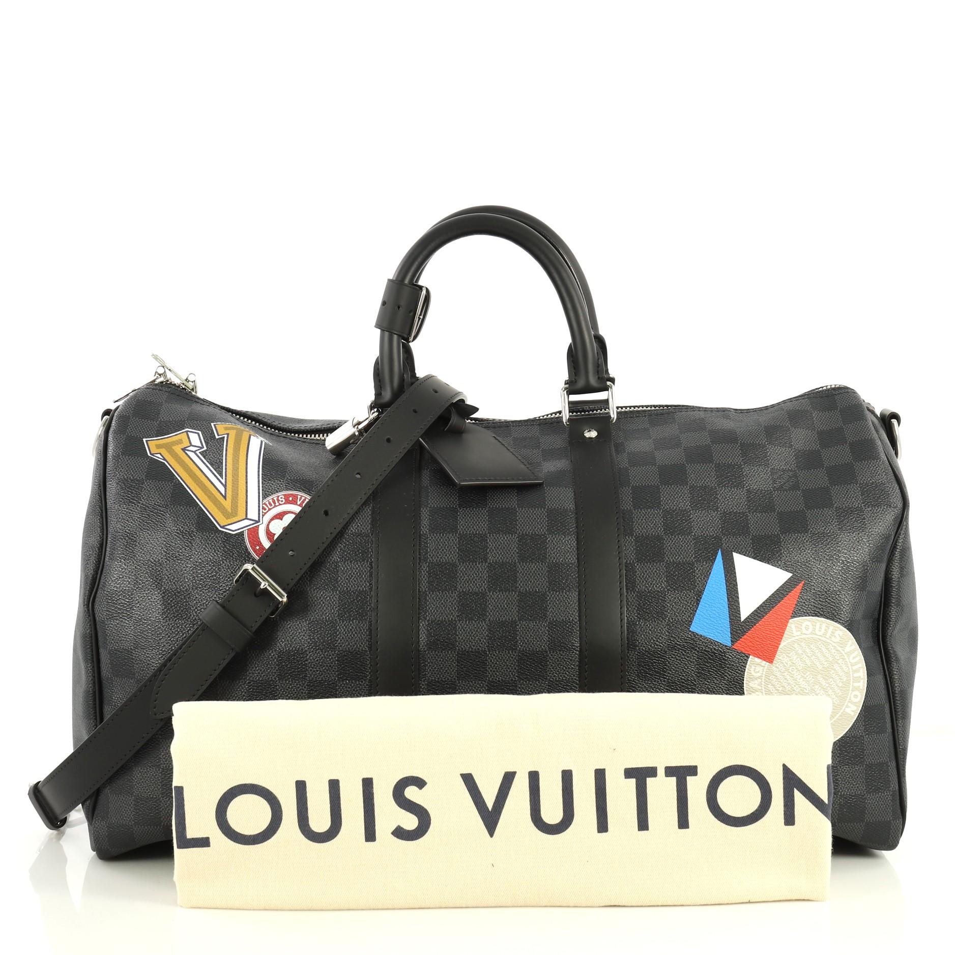 This Louis Vuitton Keepall Bandouliere Bag Limited Edition Damier Graphite LV League 45, crafted in Damier graphite coated canvas, features dual-rolled leather handles, travel patches and silver-tone hardware. Its zip closure opens to a black fabric