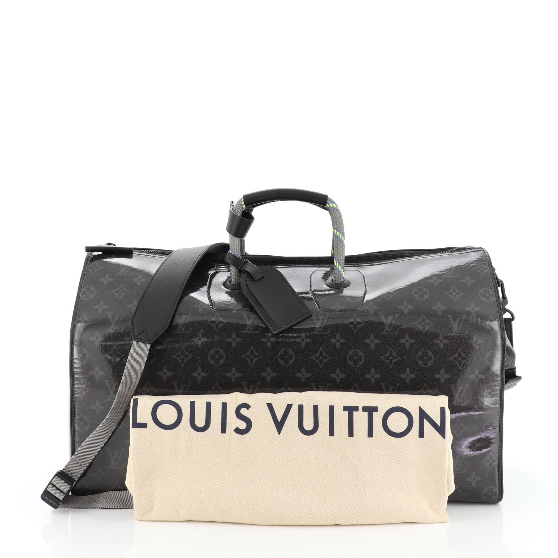 This Louis Vuitton Keepall Bandouliere Bag Limited Edition Monogram Glaze Eclipse Canvas 50, crafted in monogram glaze eclipse canvas, features dual top handles and black-tone hardware. Its zip closure opens to a black fabric interior. Authenticity