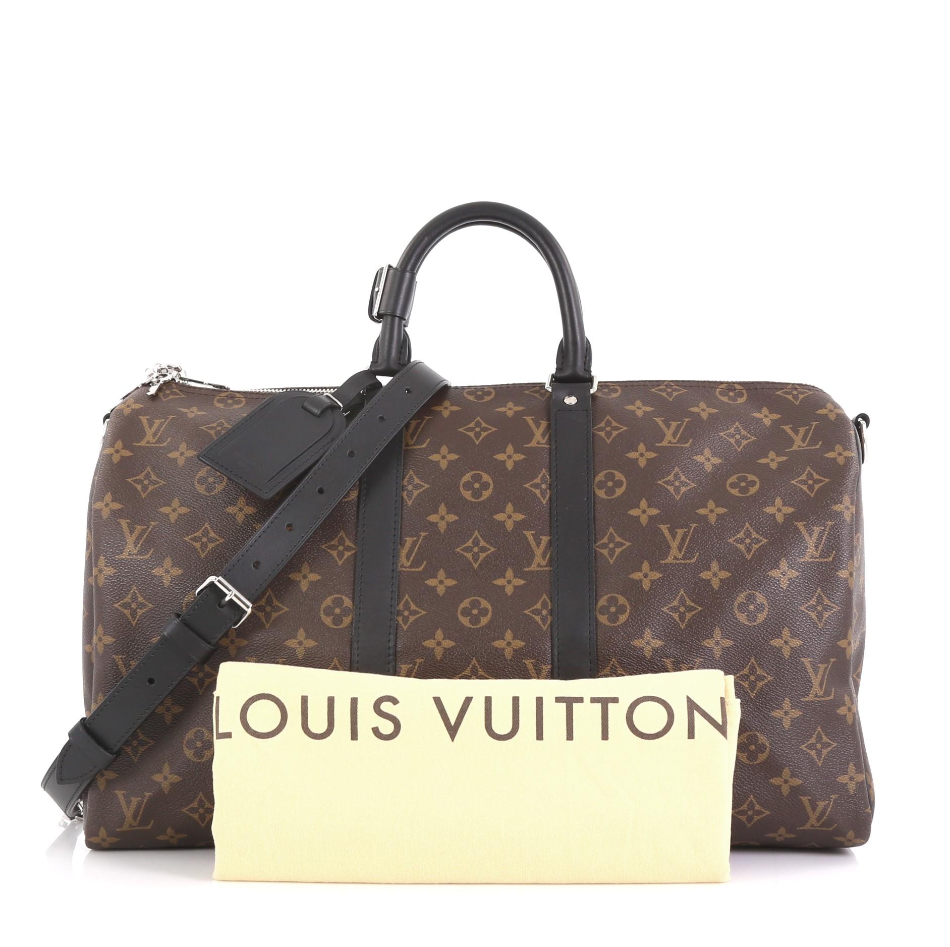 This Louis Vuitton Keepall Bandouliere Bag Macassar Monogram Canvas 45, crafted in brown macassar monogram coated canvas, features dual rolled leather handles, black leather trim, and silver-tone hardware. Its two-way zip closure opens to a burgundy