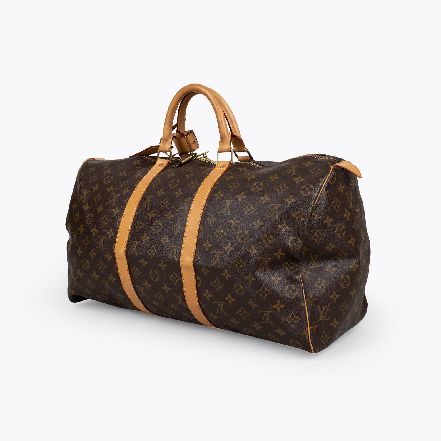 Brown and tan monogram coated canvas Louis Vuitton Keepall Monogram 50 with

- Brass hardware
- Tan vachetta leather trim
- Dual rolled top handles
- Tonal canvas lining and two-way zip closure at top

Overall Preloved Condition: Very Good
Exterior