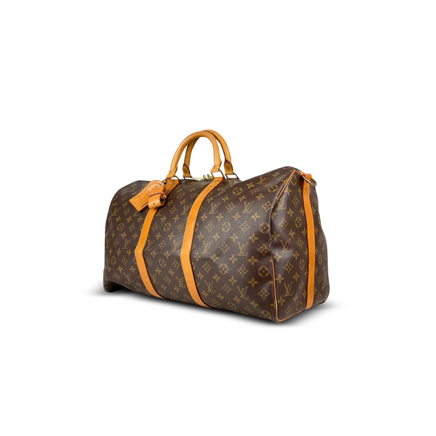 Brown and tan monogram coated canvas Louis Vuitton Keepall Bandoulière 50 with

- Brass hardware
- Tan vachetta leather trim
- Dual rolled top handles
- Tonal canvas lining and two-way zip closure at top

Overall Preloved Condition: Good
Exterior