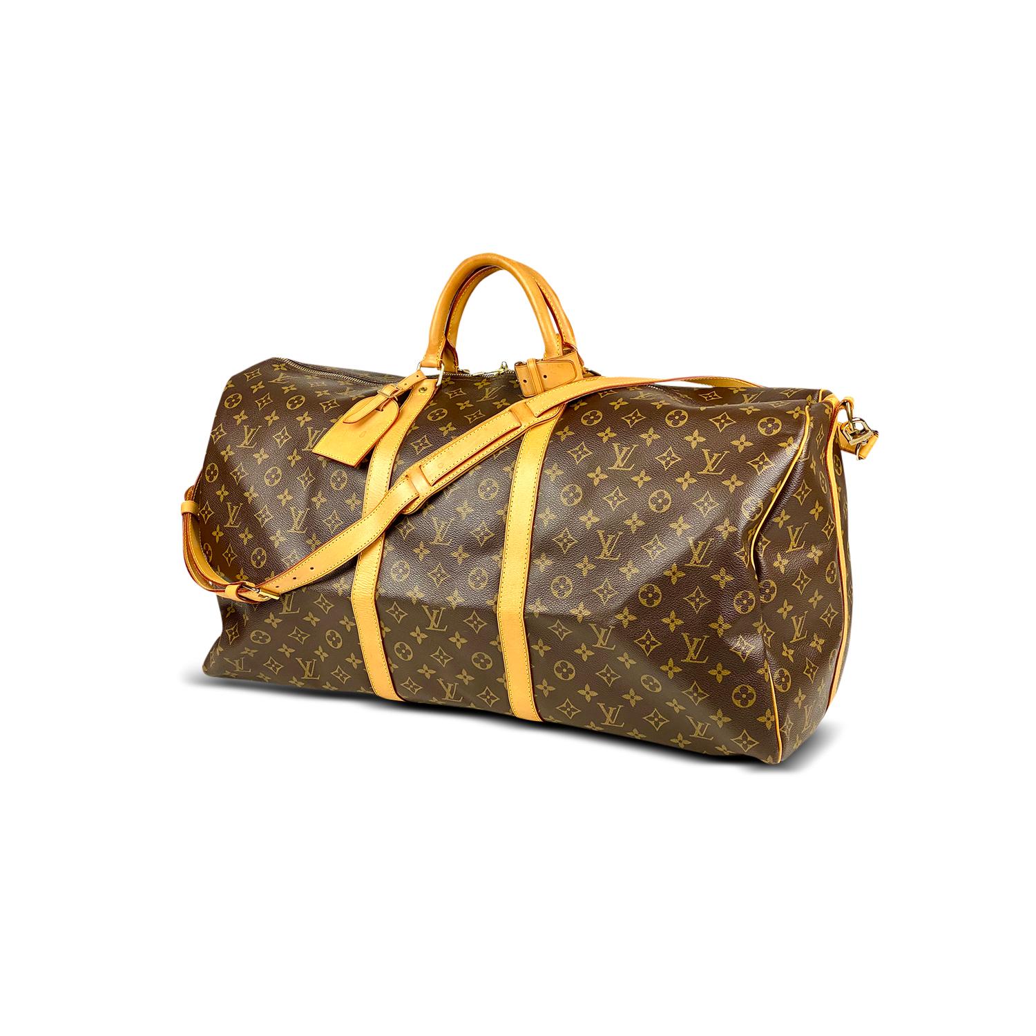 Brown and tan monogram coated canvas Louis Vuitton Keepall Bandoulière 60 with

- Brass hardware
- Tan vachetta leather trim
- Dual rolled top handles
- Tonal canvas lining and two-way zip closure at top

Overall Preloved Condition: Very