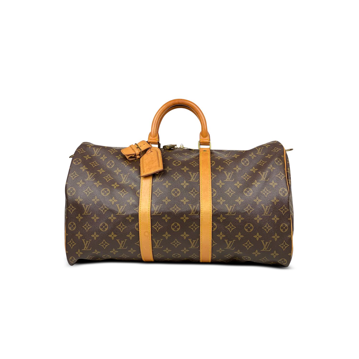 Brown and tan monogram coated canvas Louis Vuitton Keepall Bandoulière 50 with

- Brass hardware
- Tan vachetta leather trim
- Dual rolled top handles
- Tonal canvas lining and two-way zip closure at top

Overall Preloved Condition: Good

Exterior