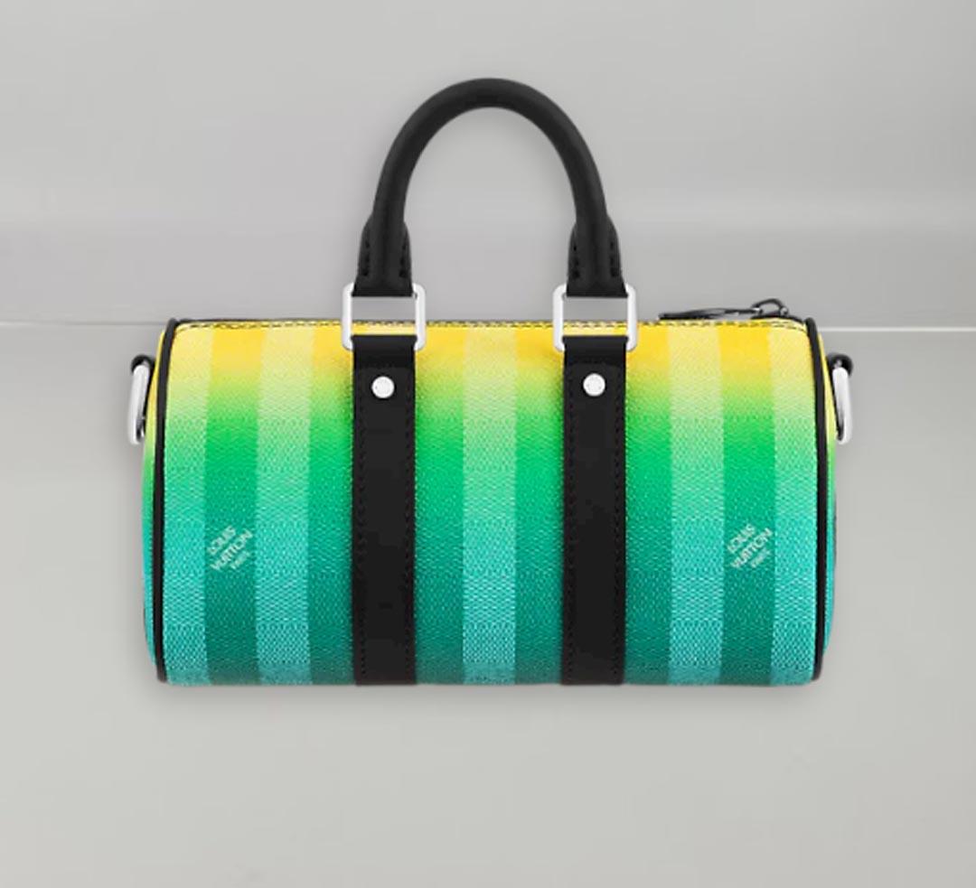 Tone-on-tone green stripes bleed into yellow on this mini Keepall XS bag made from gradient green Damier Stripes canvas. It features a new black leather Louis Vuitton patch as well as side bands, top handles and a removable strap that is also in