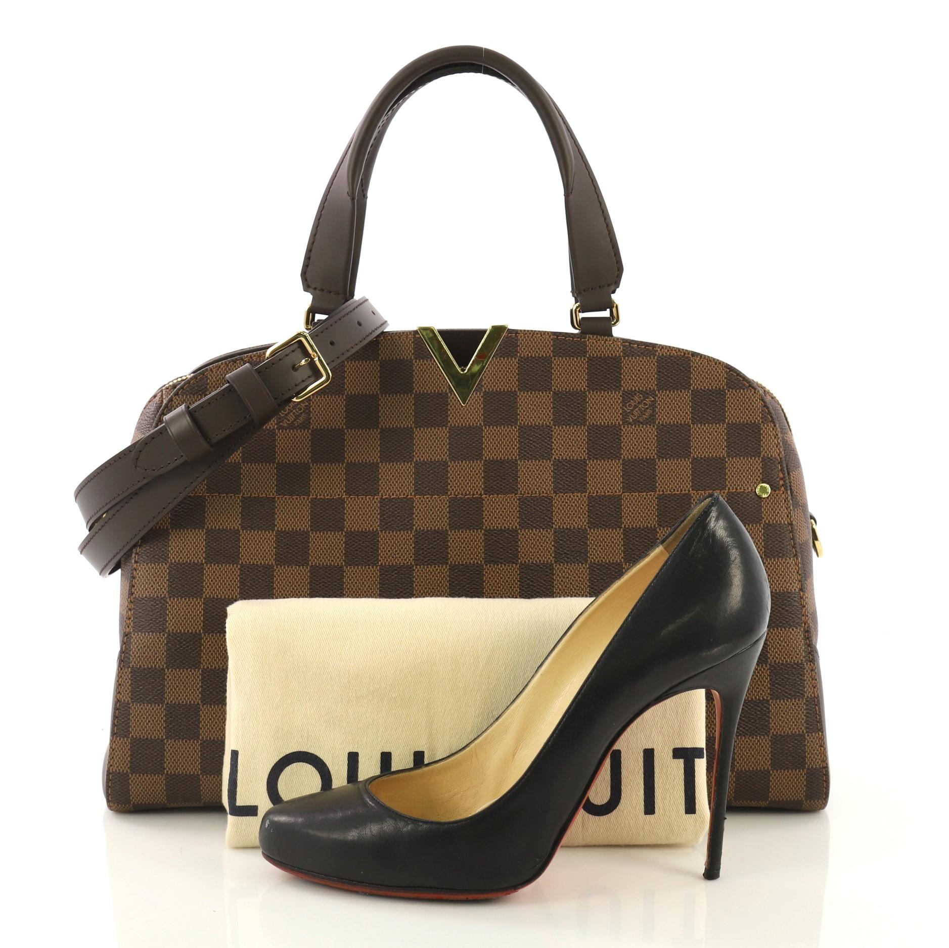 This Louis Vuitton Kensington Bowling Bag Damier, crafted from damier ebene coated canvas, features dual leather handles, brown leather trim, cut out V hardware on its top center, and gold-tone hardware. Its zip closure opens to a blush pink