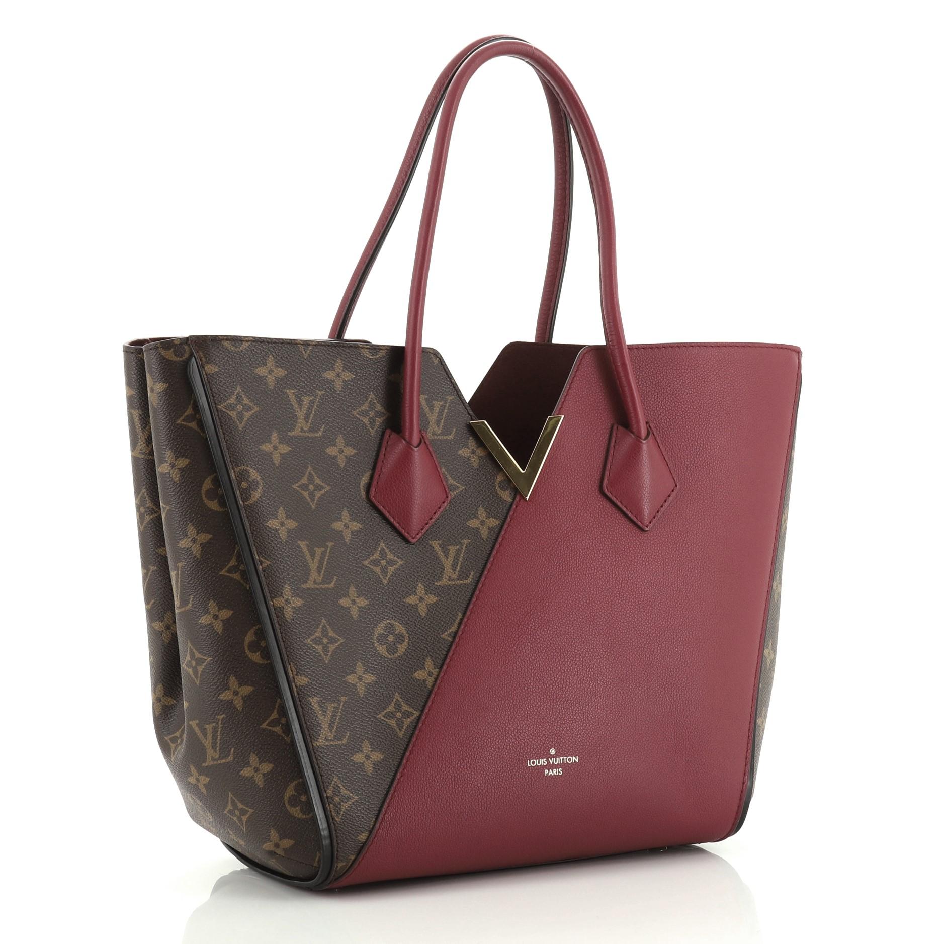 This Louis Vuitton Kimono Handbag Monogram Canvas and Leather MM, crafted from brown monogram coated canvas and red leather, features dual rolled handles, metallic V-cross accent, and gold-tone hardware. Its wide top with hook-clasp closure opens to
