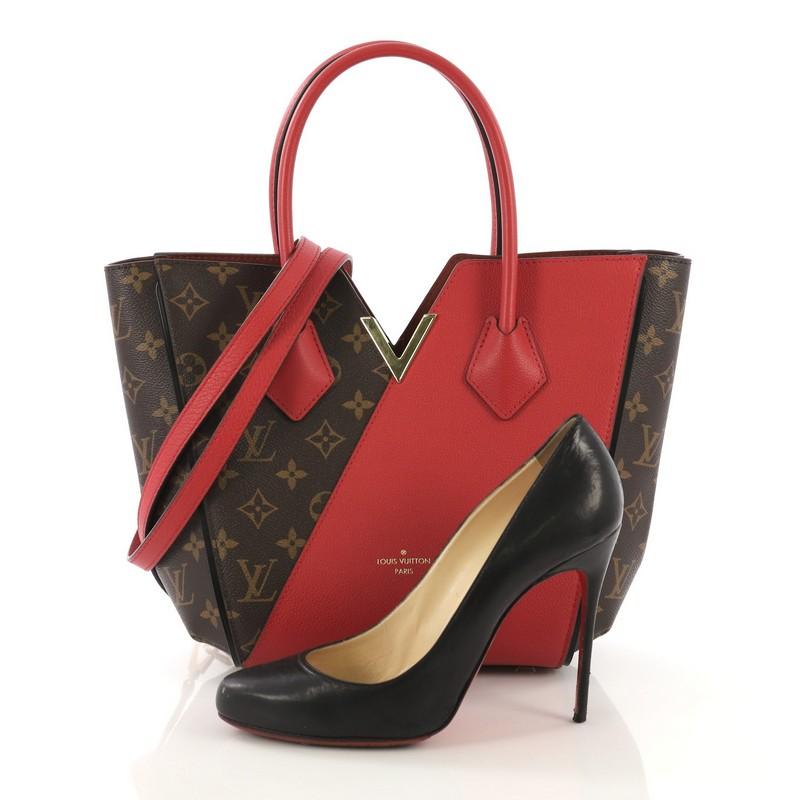 This Louis Vuitton Kimono Handbag Monogram Canvas and Leather PM, crafted from brown monogram coated canvas and red leather, features dual rolled top handles, metallic V-cross accent, and gold-tone hardware. Its wide top with hook-clasp closure