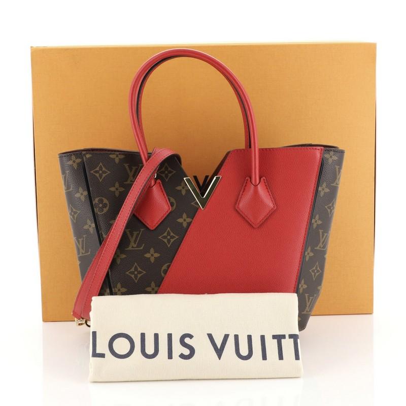 This Louis Vuitton Kimono Handbag Monogram Canvas and Leather PM, crafted from brown monogram coated canvas and red leather, features dual rolled toron top handles, metallic V-cross accent, and gold-tone hardware. Its wide top with hook-clasp